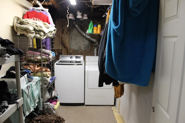 washroom with washing machine and dryer and laundry area