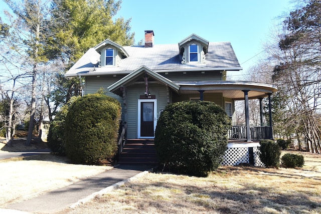 view of front of property featuring a porch and a chimney