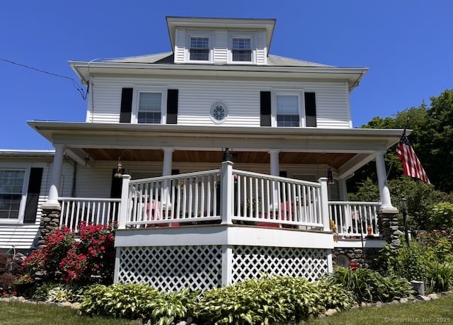 traditional style home featuring covered porch