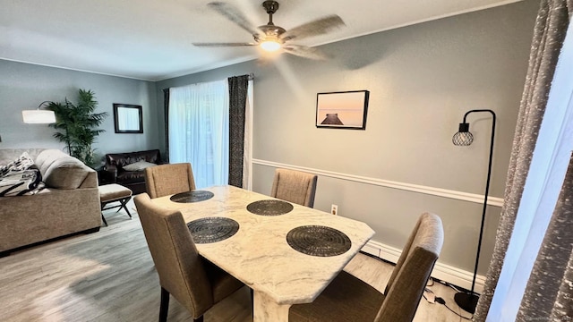 dining space featuring ceiling fan and wood finished floors