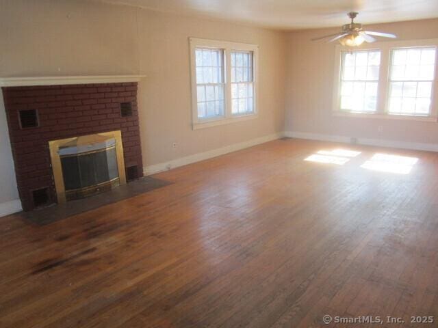 242 Elm St, Enfield, CT 06082 - unfurnished living room featuring wood finished floors, baseboards, ceiling fan, and a brick fireplace