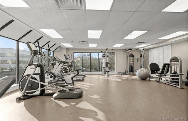 exercise room with a paneled ceiling and visible vents