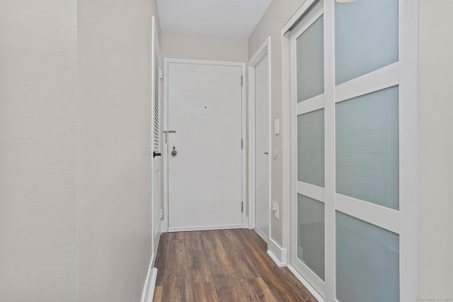 hallway with wood finished floors and baseboards