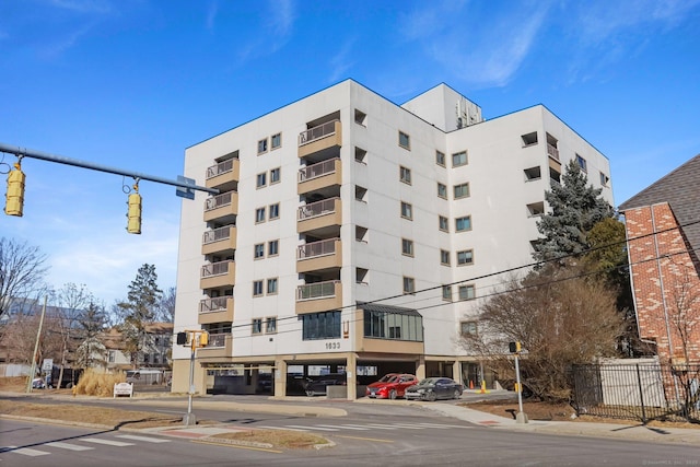 view of building exterior featuring uncovered parking