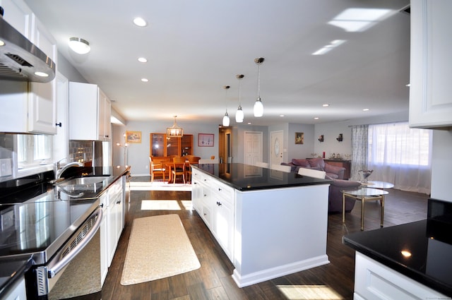 kitchen with recessed lighting, exhaust hood, white cabinetry, dark countertops, and dark wood finished floors