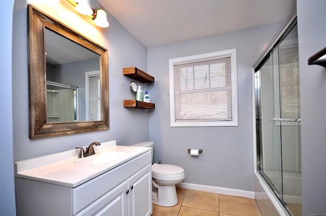 bathroom with tile patterned flooring, baseboards, vanity, and toilet