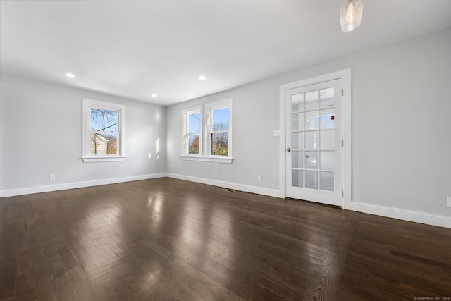 unfurnished room featuring dark wood-style floors, recessed lighting, and baseboards