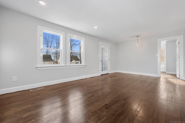 unfurnished living room with recessed lighting, wood-type flooring, visible vents, and baseboards