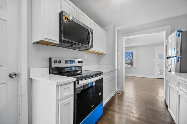 kitchen with baseboards, white cabinets, dark wood finished floors, stainless steel appliances, and light countertops