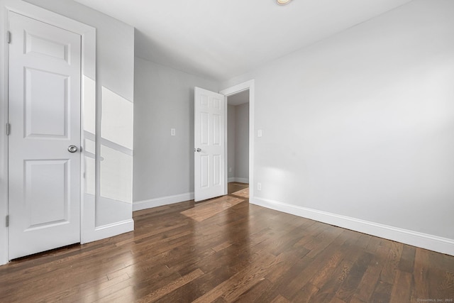 unfurnished bedroom with wood-type flooring and baseboards