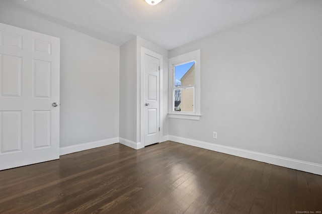 additional living space featuring wood finished floors and baseboards