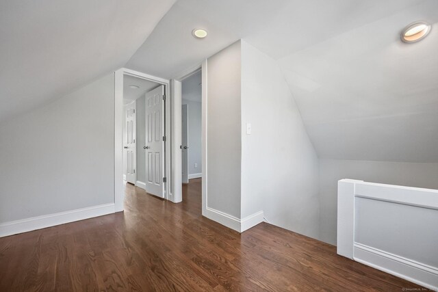 bonus room featuring vaulted ceiling, wood finished floors, and baseboards