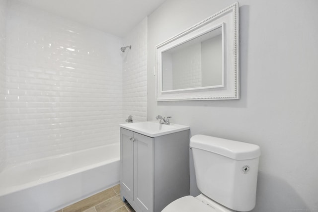 bathroom with bathing tub / shower combination, vanity, and toilet