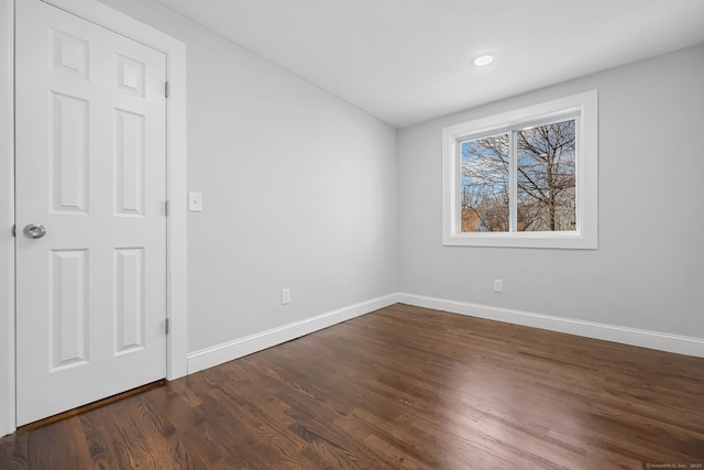 unfurnished bedroom featuring dark wood-style floors and baseboards