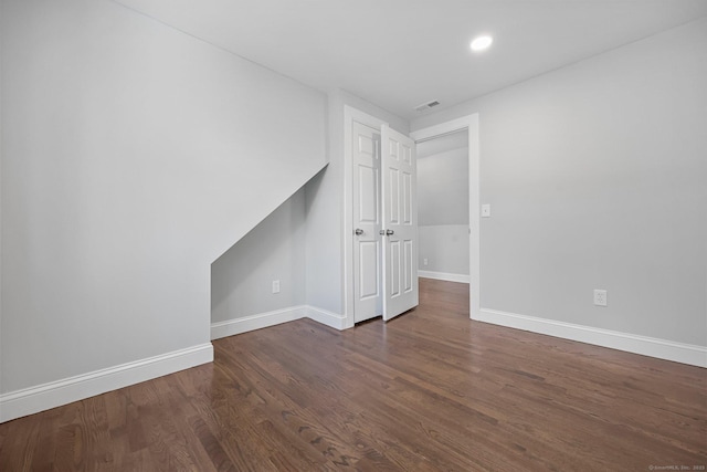 unfurnished room featuring dark wood-type flooring, recessed lighting, visible vents, and baseboards