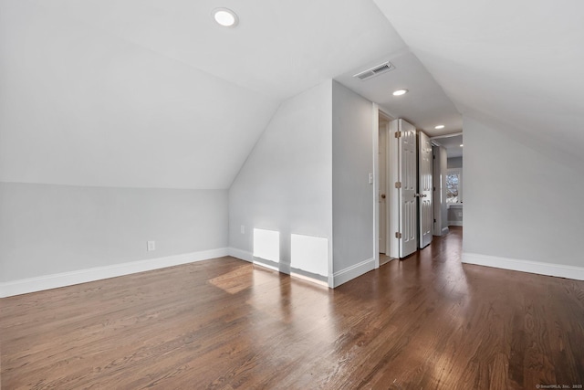 additional living space with recessed lighting, visible vents, vaulted ceiling, wood finished floors, and baseboards