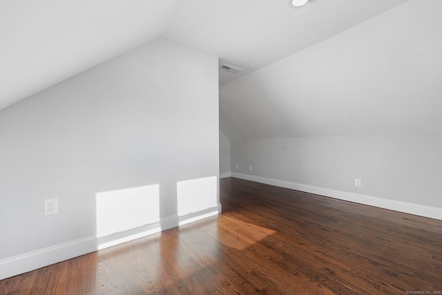 bonus room featuring vaulted ceiling, wood finished floors, visible vents, and baseboards