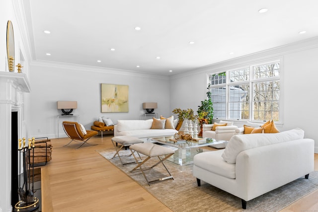 living room with baseboards, wood finished floors, crown molding, a fireplace, and recessed lighting