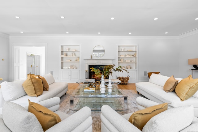 living room with a lit fireplace, wood finished floors, and recessed lighting