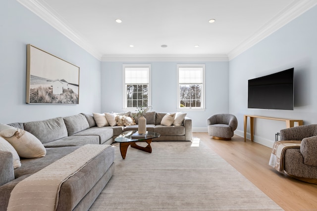 living room with ornamental molding, recessed lighting, light wood-style floors, and baseboards