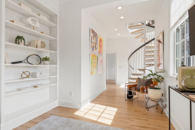 foyer with crown molding, recessed lighting, light wood-style floors, baseboards, and stairs