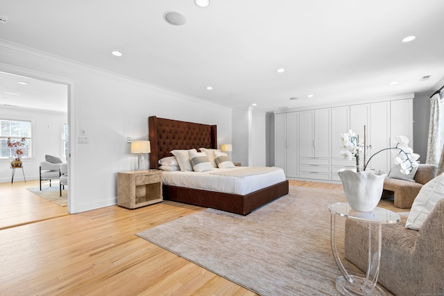 bedroom with ornamental molding, light wood finished floors, baseboards, and recessed lighting