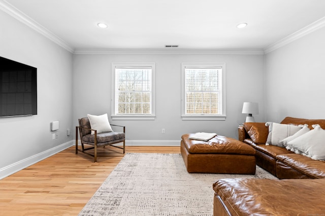 living area with ornamental molding, light wood-type flooring, baseboards, and recessed lighting