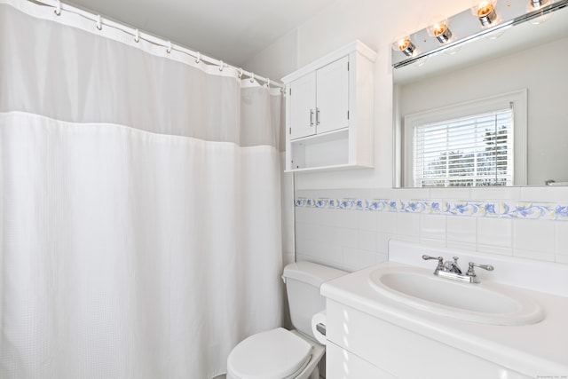 full bath with toilet, tile walls, and vanity