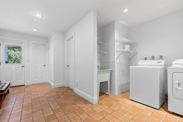 laundry room featuring laundry area, light tile patterned floors, washer and clothes dryer, and recessed lighting