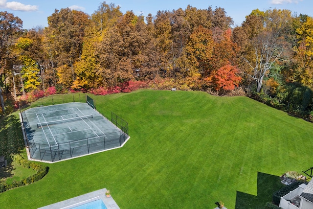 view of yard featuring a tennis court and fence