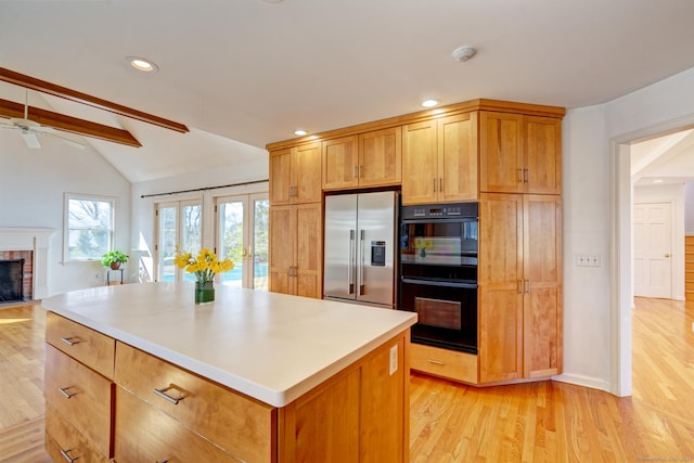 37 Skyline Dr, Groton, CT 06340 - kitchen with stainless steel fridge with ice dispenser, a fireplace, light wood-style flooring, ceiling fan, and a center island