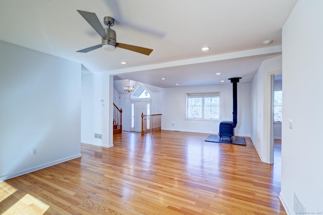 37 Skyline Dr, Groton, CT 06340 - unfurnished living room featuring a wood stove, light wood-style floors, a ceiling fan, a chandelier, and recessed lighting