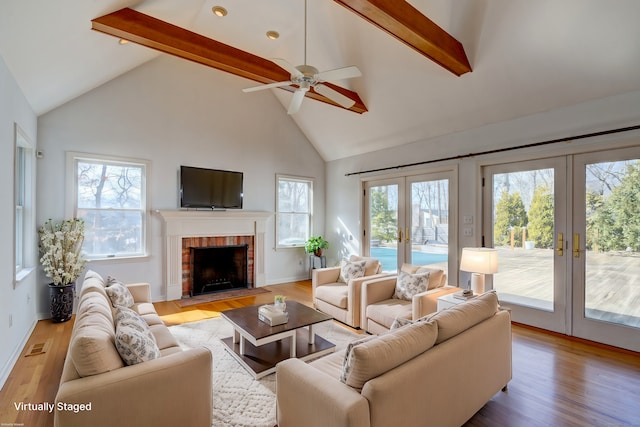 37 Skyline Dr, Groton, CT 06340 - living area featuring french doors, high vaulted ceiling, beamed ceiling, plenty of natural light, and light wood finished floors