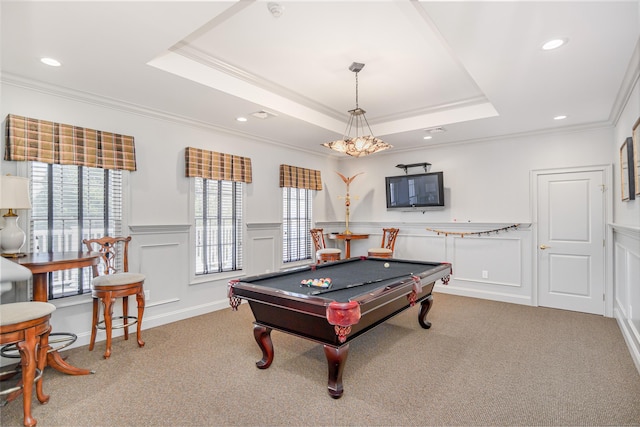 game room featuring ornamental molding, carpet, a decorative wall, and a tray ceiling