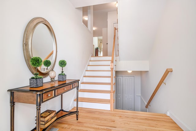 staircase with wood finished floors and baseboards