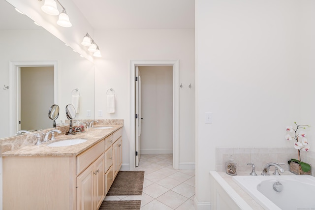 full bathroom featuring double vanity, a sink, a bathtub, and tile patterned floors