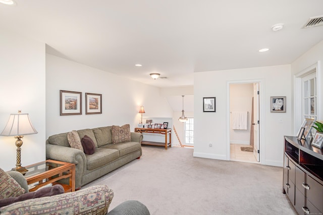 living area with recessed lighting, visible vents, baseboards, and light colored carpet