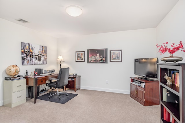 home office with light colored carpet, visible vents, and baseboards