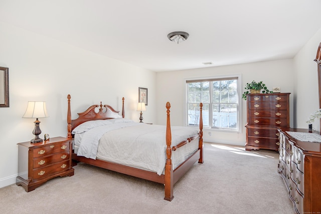 bedroom featuring light carpet and visible vents