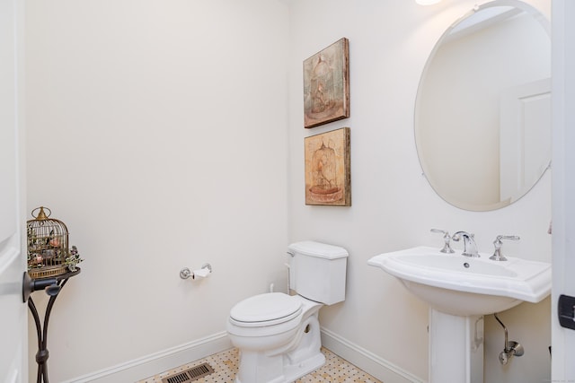 bathroom with visible vents, tile patterned floors, toilet, and baseboards