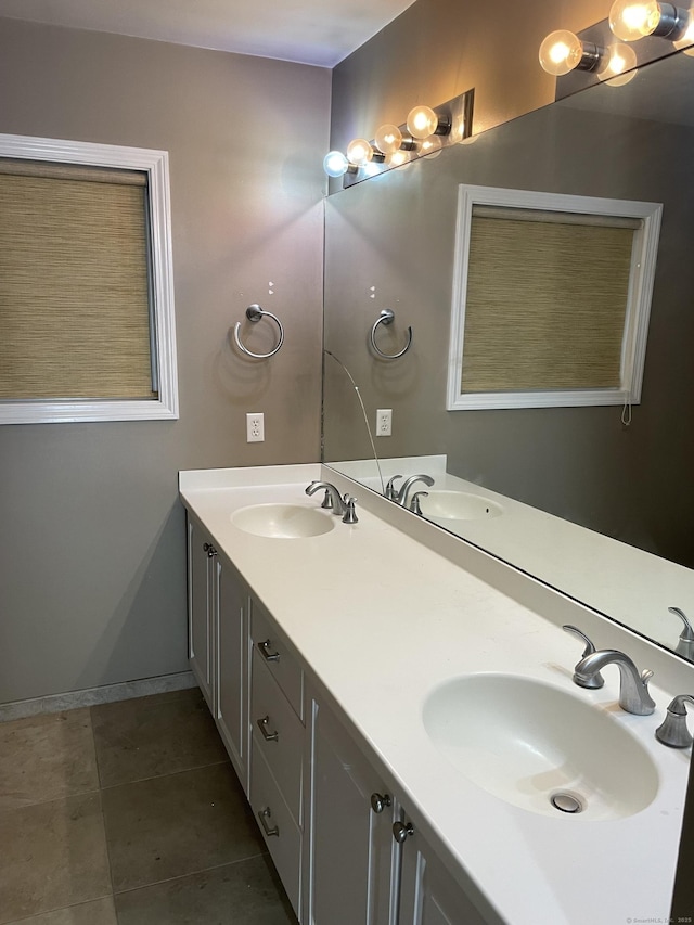 full bathroom featuring double vanity, tile patterned flooring, and a sink