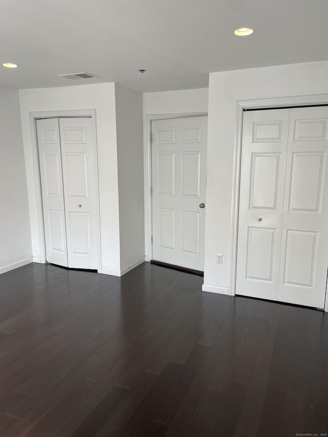 2660 N Ave Unit 110, Bridgeport, CT 06604 - unfurnished bedroom with baseboards, recessed lighting, a closet, and dark wood-style flooring