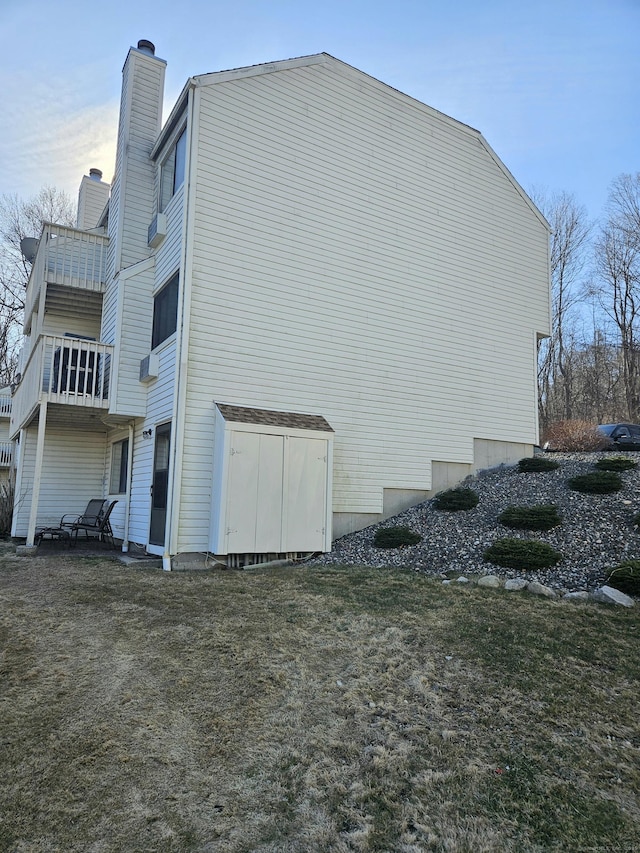 view of home's exterior with a lawn and a chimney