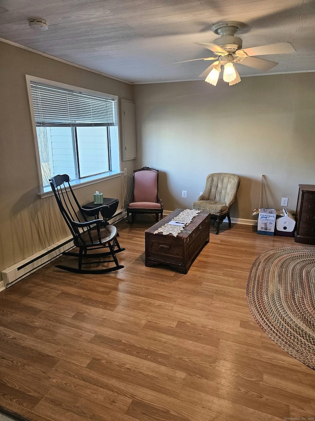 sitting room featuring a ceiling fan, wood finished floors, and baseboards