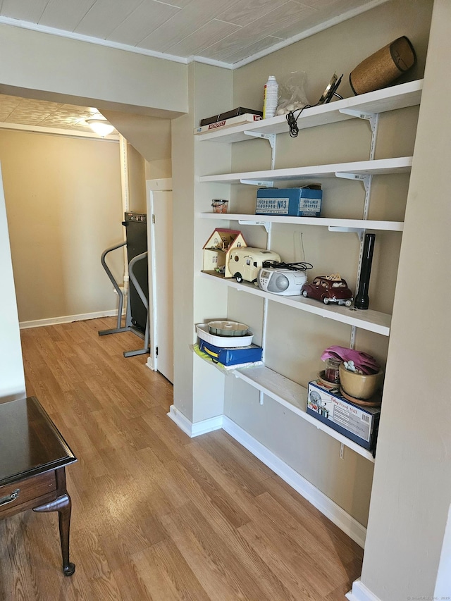 interior space featuring baseboards and wood finished floors