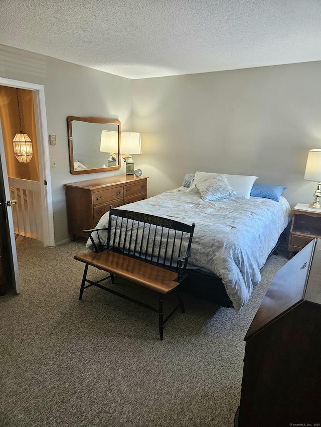 carpeted bedroom with a textured ceiling