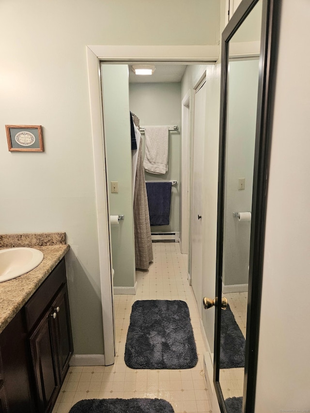 bathroom with tile patterned floors, vanity, and baseboards