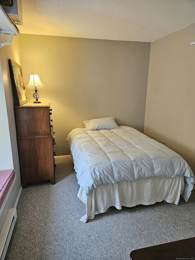 carpeted bedroom featuring a textured ceiling and baseboard heating