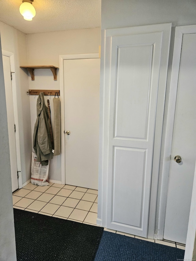 interior space featuring tile patterned flooring and a textured ceiling