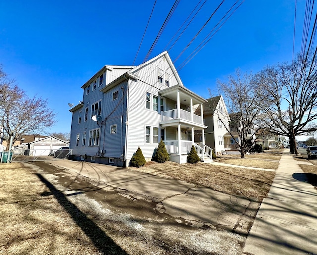 view of property exterior with a balcony and a porch